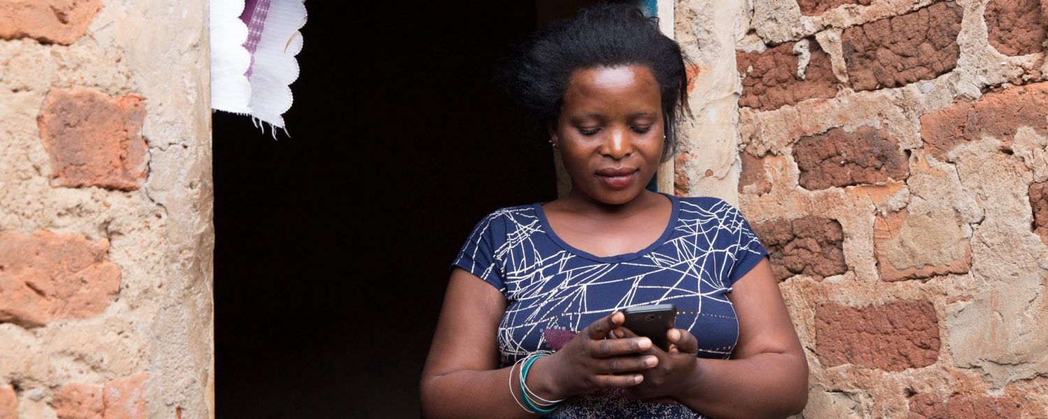 Jane Zamukunda (28) accesses Barefoot Law's free legal advice through her mobile phone at her brother's house in Kawempe, Kampala on 19th May 2017.